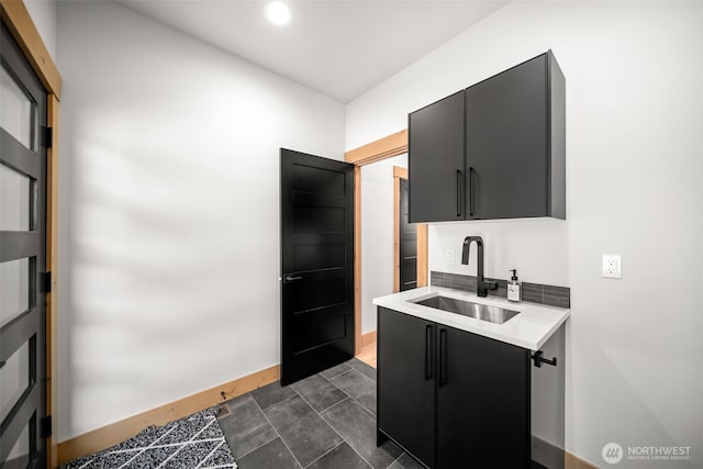 141 Pebble Beach Dr, Cle Elum, WA 98922 - kitchen featuring a sink, dark cabinetry, light countertops, tasteful backsplash, and recessed lighting