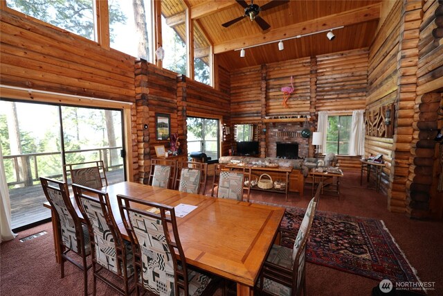 215 Marine Dr, Blakely Island, WA 98222 - carpeted dining space with high vaulted ceiling, a fireplace, wooden ceiling with exposed beams, healthy amount of natural light, and ceiling fan