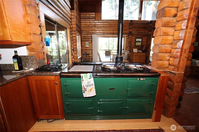 215 Marine Dr, Blakely Island, WA 98222 - kitchen with rustic walls, healthy amount of natural light, stainless steel gas stovetop, light wood-style flooring, and a high ceiling