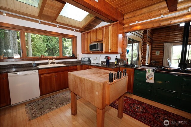 215 Marine Dr, Blakely Island, WA 98222 - kitchen featuring dishwasher, rustic walls, a sink, wooden ceiling with exposed beams, and light wood-style flooring