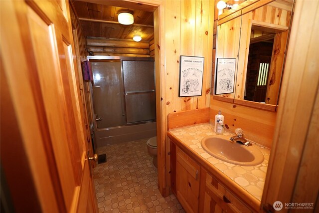 215 Marine Dr, Blakely Island, WA 98222 - bathroom featuring toilet, vanity, wooden ceiling, and shower / bath combination with glass door