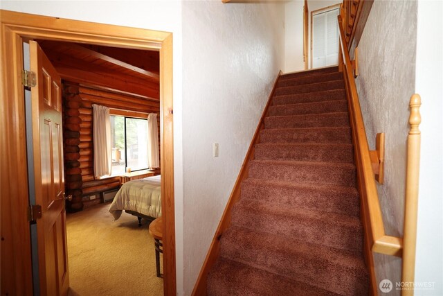 215 Marine Dr, Blakely Island, WA 98222 - stairway with rustic walls, carpet floors, and baseboards