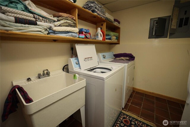 215 Marine Dr, Blakely Island, WA 98222 - washroom featuring electric panel, washing machine and clothes dryer, tile patterned floors, and baseboards