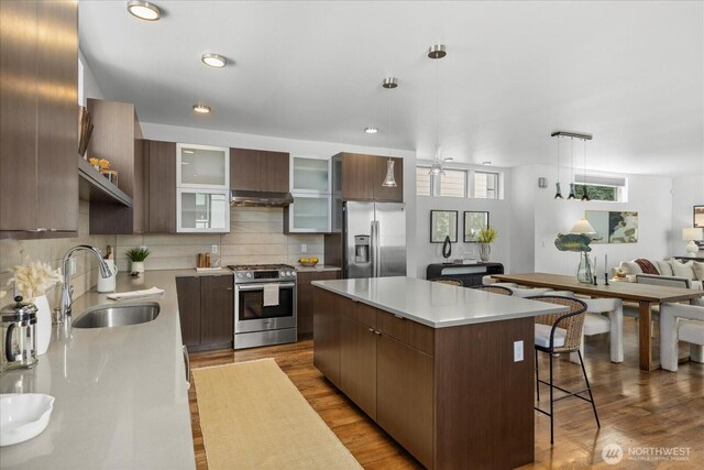 8838 Interlake Ave N, Seattle, WA 98103 - kitchen with appliances with stainless steel finishes, a sink, modern cabinets, a kitchen island, and recessed lighting