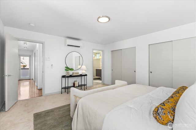 8838 Interlake Ave N, Seattle, WA 98103 - carpeted bedroom featuring an AC wall unit, two closets, ensuite bath, and baseboards