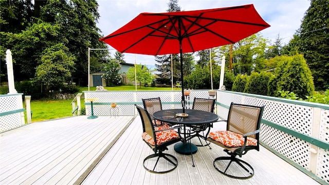 31405 10th Ave S, Federal Way, WA 98003 - wooden terrace with outdoor dining space, a yard, and view of wooded area