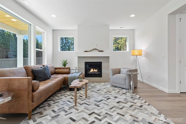 11210 79th Avenue Ct SW, Lakewood, WA 98498 - living room with a tiled fireplace, wood finished floors, recessed lighting, and baseboards