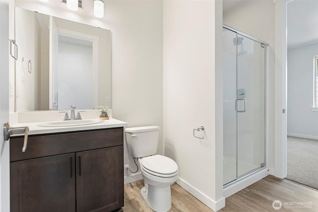 11210 79th Avenue Ct SW, Lakewood, WA 98498 - bathroom with wood finished floors, a shower stall, baseboards, and vanity
