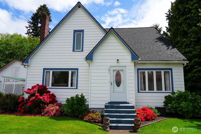 181 N 2nd St, Morton, WA 98356 - bungalow with a chimney, a front yard, roof with shingles, and central AC unit