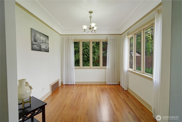 181 N 2nd St, Morton, WA 98356 - empty room featuring a chandelier, light wood-style floors, and baseboards
