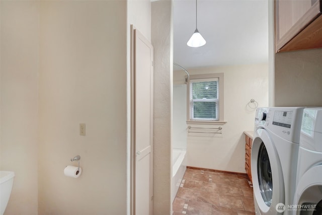 181 N 2nd St, Morton, WA 98356 - laundry room featuring washer / dryer, baseboards, and light stone finish floors