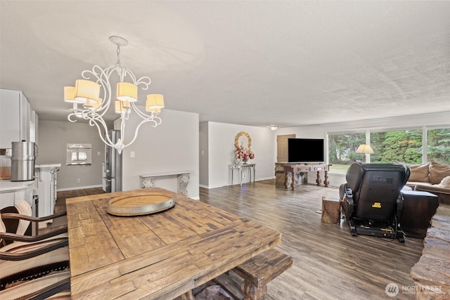 7938 E Leavenworth Rd, Leavenworth, WA 98826 - dining space featuring a chandelier, wood finished floors, and baseboards