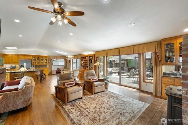28118 163rd St E, Wilkeson, WA 98396 - living room featuring a ceiling fan, lofted ceiling, a chandelier, wood finished floors, and recessed lighting