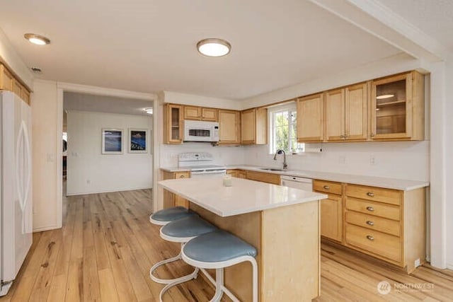 2040 Spruce, Woodland, WA 98674 - kitchen with white appliances, light wood-style floors, light countertops, and a kitchen breakfast bar