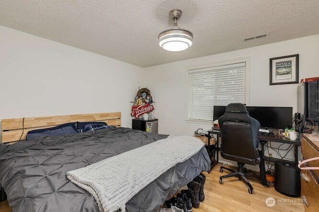 2040 Spruce, Woodland, WA 98674 - bedroom with wood finished floors, a textured ceiling, and an office area