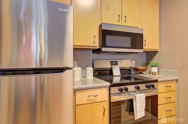 10800 SE 17th Cir Unit D50, Vancouver, WA 98664 - kitchen featuring appliances with stainless steel finishes, light brown cabinetry, and light stone counters