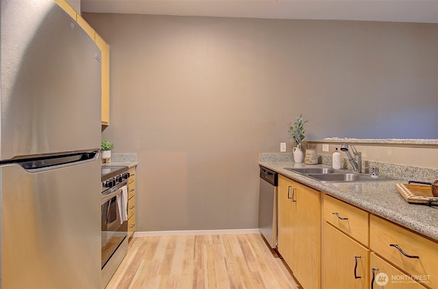 10800 SE 17th Cir Unit D50, Vancouver, WA 98664 - kitchen featuring appliances with stainless steel finishes, light wood-type flooring, light countertops, and light brown cabinets