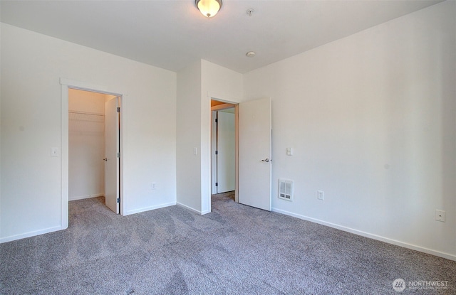 10800 SE 17th Cir Unit D50, Vancouver, WA 98664 - unfurnished bedroom featuring carpet floors and a walk in closet