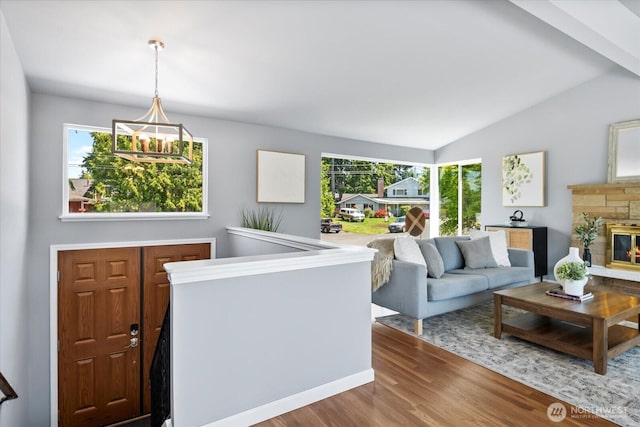 22606 87th Ave W, Edmonds, WA 98026 - living area featuring wood finished floors, plenty of natural light, vaulted ceiling, and a stone fireplace