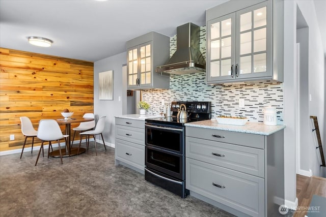 22606 87th Ave W, Edmonds, WA 98026 - kitchen featuring wall chimney exhaust hood, stainless steel range with electric stovetop, gray cabinets, tasteful backsplash, and wood walls