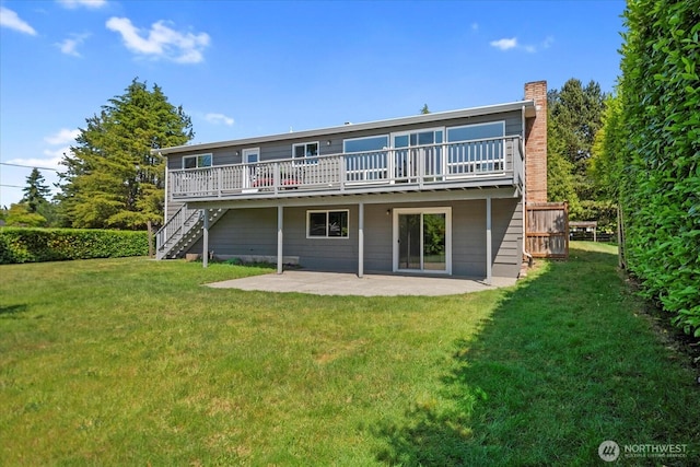 22606 87th Ave W, Edmonds, WA 98026 - back of property featuring stairway, a wooden deck, a patio area, a lawn, and a chimney