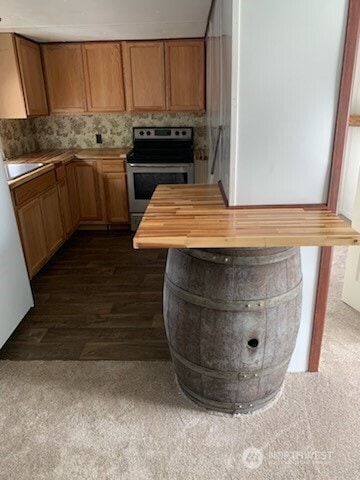 38 Hurd St Unit 33, Elma, WA 98541 - kitchen featuring stainless steel range with electric stovetop, dark wood-style floors, and wood counters