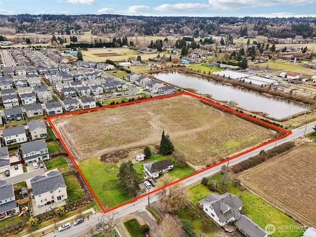 3102 16th Ave NW, Puyallup, WA 98371 - aerial perspective of suburban area with a large body of water and property parcel outlined
