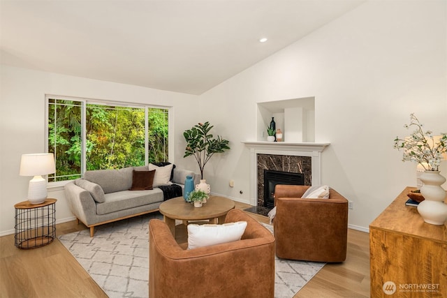 3816 NE 110th St, Seattle, WA 98125 - living room with light wood finished floors, lofted ceiling, a fireplace, and recessed lighting