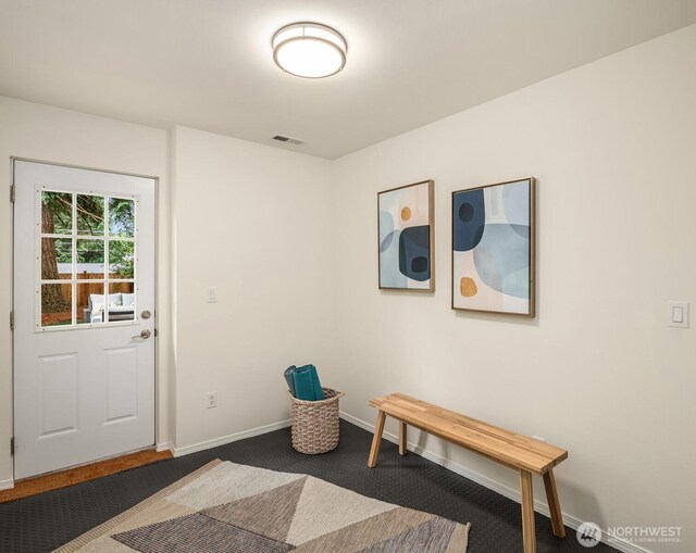 3816 NE 110th St, Seattle, WA 98125 - entryway featuring dark colored carpet and baseboards
