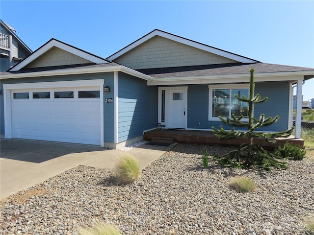 417 Riviera St SW, Ocean Shores, WA 98569 - ranch-style home featuring an attached garage, concrete driveway, a porch, and roof with shingles