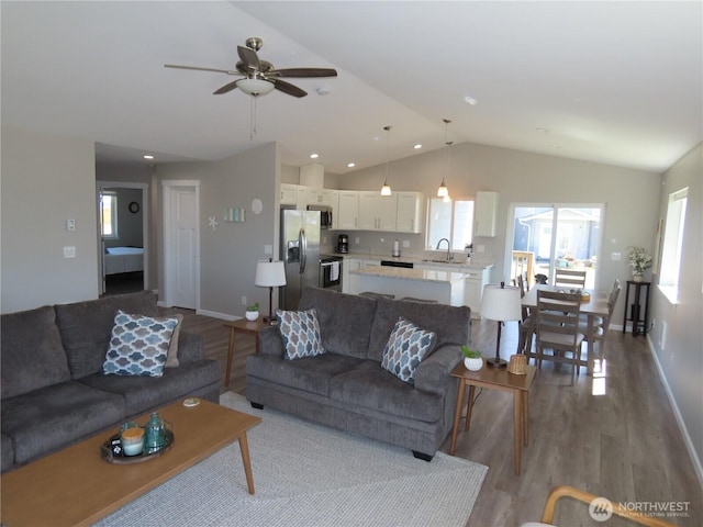 417 Riviera St SW, Ocean Shores, WA 98569 - living room with lofted ceiling, wood finished floors, ceiling fan, and baseboards