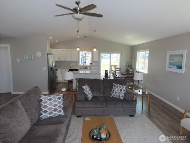 417 Riviera St SW, Ocean Shores, WA 98569 - living area with lofted ceiling, wood finished floors, baseboards, and a ceiling fan