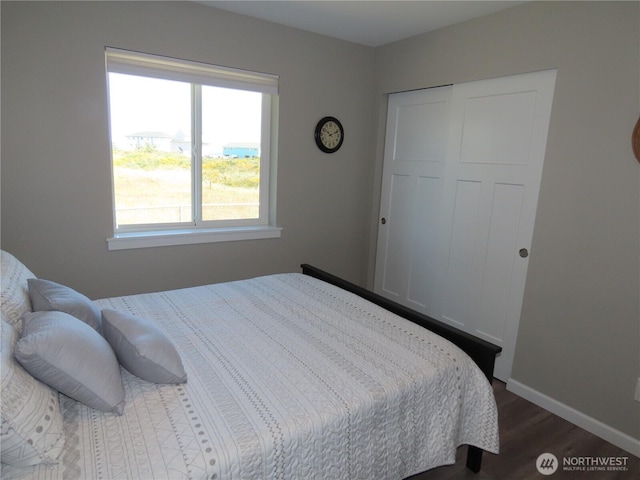 417 Riviera St SW, Ocean Shores, WA 98569 - bedroom with wood finished floors, multiple windows, a closet, and baseboards