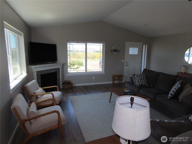 417 Riviera St SW, Ocean Shores, WA 98569 - living area with healthy amount of natural light, wood finished floors, lofted ceiling, a fireplace, and baseboards