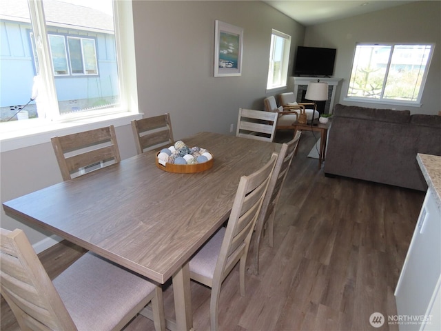 417 Riviera St SW, Ocean Shores, WA 98569 - dining room featuring dark wood-style floors and vaulted ceiling