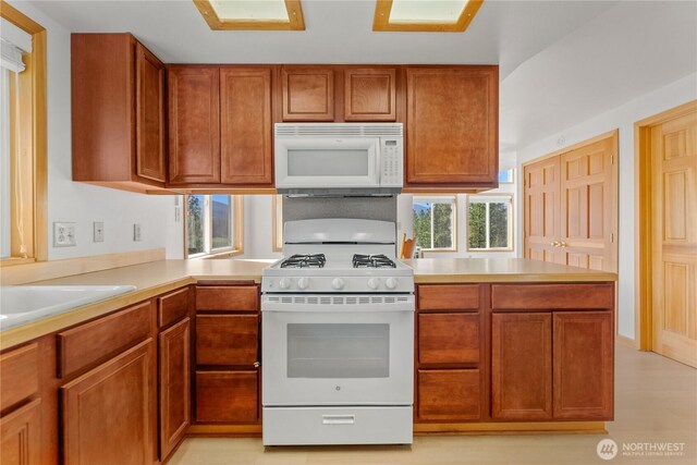 11 Appaloosa Rd, Winthrop, WA 98862 - kitchen with white appliances, light countertops, and brown cabinetry