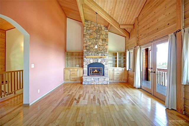 1051 Lightning Way, Camano Island, WA 98282 - unfurnished living room with hardwood / wood-style floors, a fireplace, high vaulted ceiling, wooden ceiling with exposed beams, and french doors