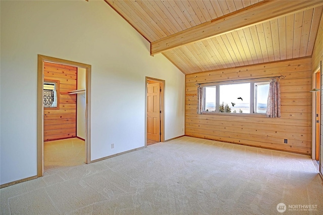 1051 Lightning Way, Camano Island, WA 98282 - unfurnished bedroom featuring light carpet, wooden walls, wooden ceiling with exposed beams, baseboards, and a spacious closet