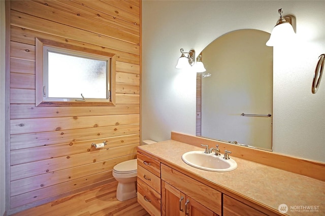1051 Lightning Way, Camano Island, WA 98282 - bathroom with vanity, toilet, wood finished floors, and wooden walls