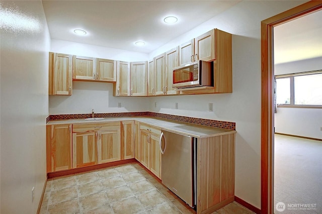 1051 Lightning Way, Camano Island, WA 98282 - kitchen featuring stainless steel microwave, a sink, light brown cabinetry, and baseboards