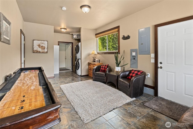 1751 Stone Ridge Dr, Cle Elum, WA 98922 - living area featuring estacked washer and dryer, electric panel, stone tile floors, and baseboards