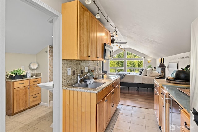 1751 Stone Ridge Dr, Cle Elum, WA 98922 - kitchen with lofted ceiling, a sink, a ceiling fan, light tile patterned floors, and open floor plan
