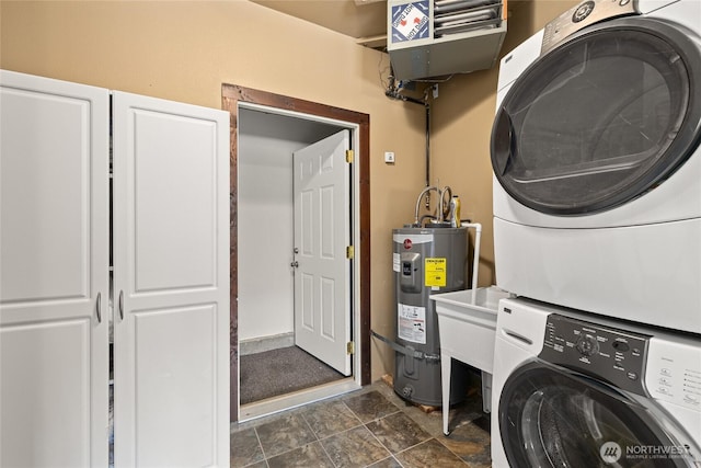 1751 Stone Ridge Dr, Cle Elum, WA 98922 - laundry room with stacked washing machine and dryer, electric water heater, and a heating unit