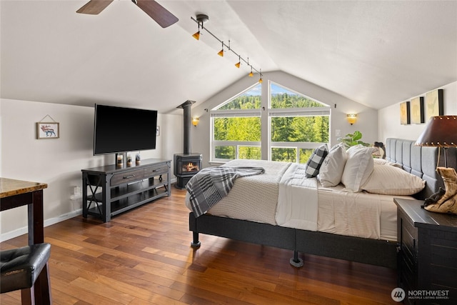 1751 Stone Ridge Dr, Cle Elum, WA 98922 - bedroom with lofted ceiling, a wood stove, hardwood / wood-style flooring, baseboards, and a ceiling fan