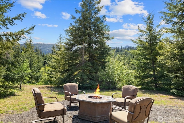 1751 Stone Ridge Dr, Cle Elum, WA 98922 - view of patio with a fire pit and a wooded view