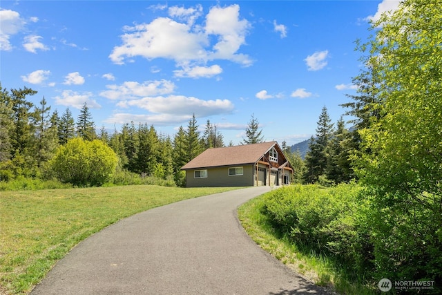 1751 Stone Ridge Dr, Cle Elum, WA 98922 - view of front of property featuring asphalt driveway, a front yard, and a garage