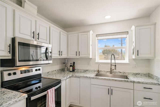 1123 Mather Dr, Moses Lake, WA 98837 - kitchen with stainless steel appliances, a sink, white cabinets, and recessed lighting