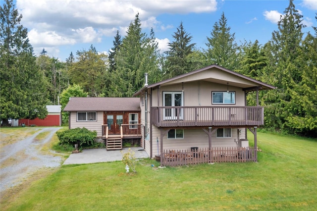21410 161st Ave E, Graham, WA 98338 - rear view of house with french doors, a lawn, gravel driveway, a deck, and a patio area