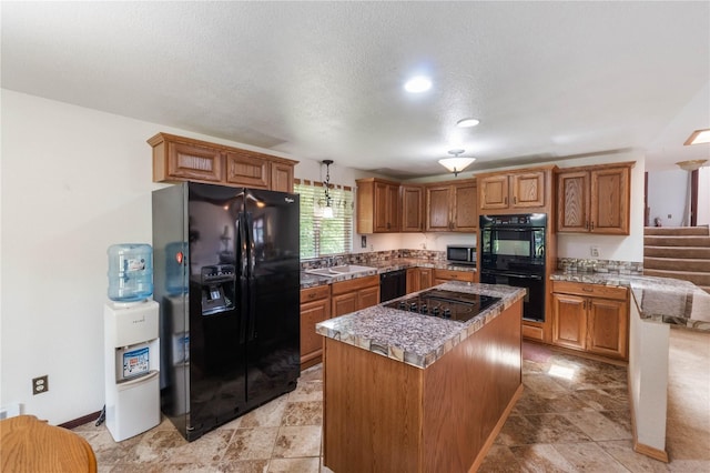 21410 161st Ave E, Graham, WA 98338 - kitchen featuring black appliances, a sink, brown cabinets, a center island, and hanging light fixtures