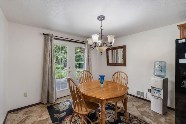 21410 161st Ave E, Graham, WA 98338 - dining room featuring a chandelier, french doors, baseboards, a textured ceiling, and light stone finish floors